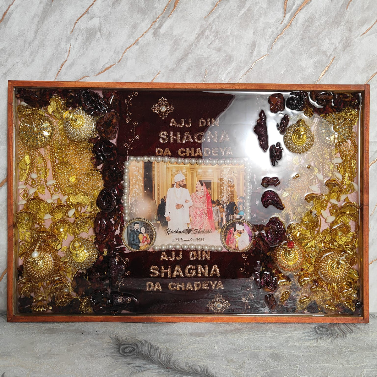 Large wooden frame with gold kaleere on both sides, dried roses, couple photo and Ajj Din Shagna Da Chadeya text