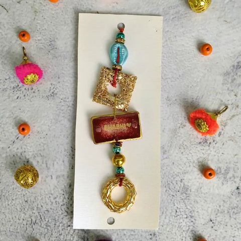 Red Resin Couple Rakhi For Bhaiya Bhabhi