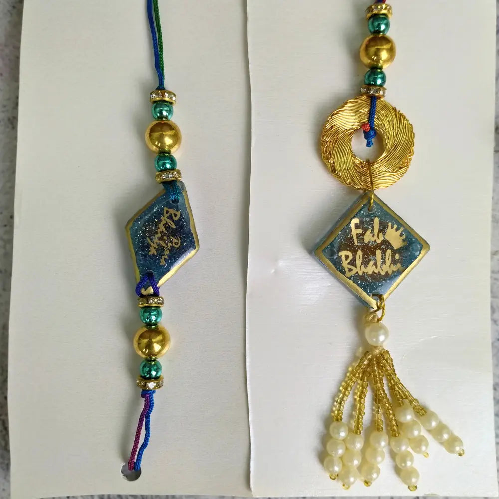 Purple & Gold Resin Couple Rakhi For Pyara Bhaiya Bhabhi (Set Of Two)