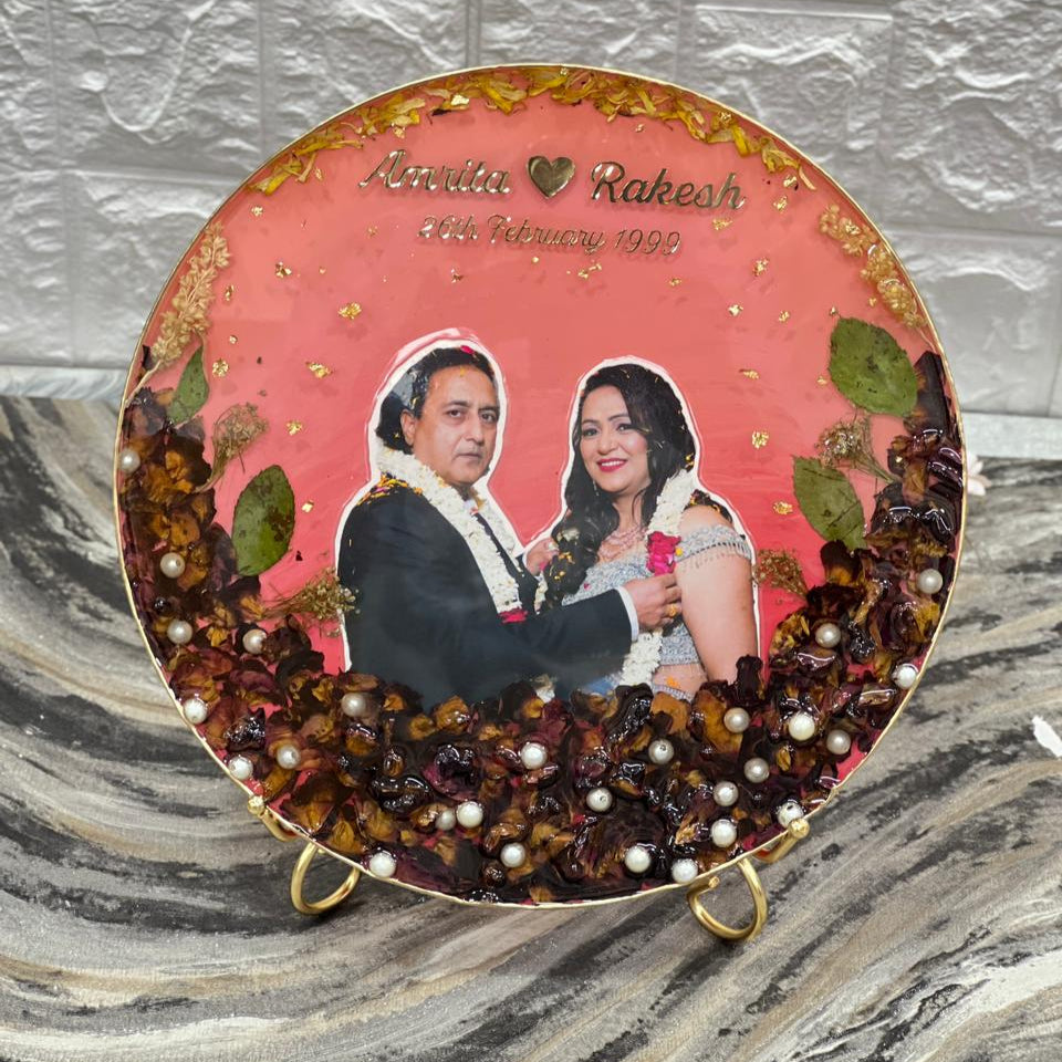 8 inch round varmala preservation table frame with pink base, dark roses below