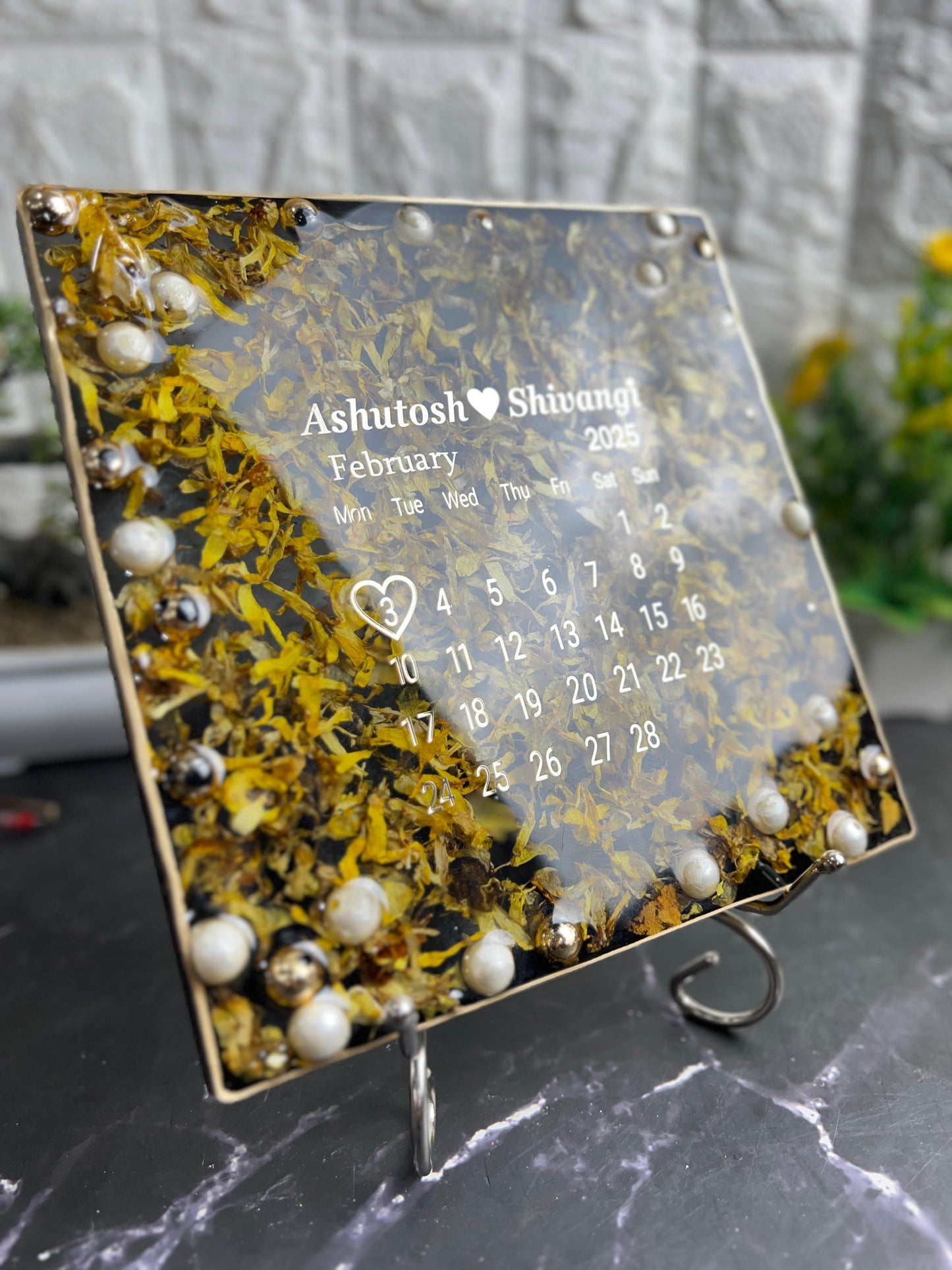 Resin 8 inch square frame with   black base petals and name date n calendar on the top with metal stand  Varmala Preservation
