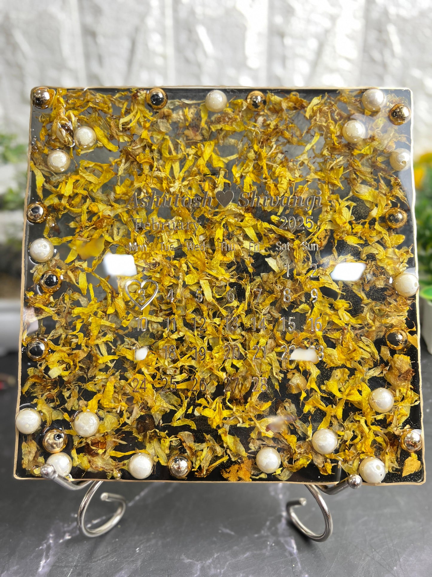 Resin 8 inch square frame with   black base petals and name date n calendar on the top with metal stand  Varmala Preservation