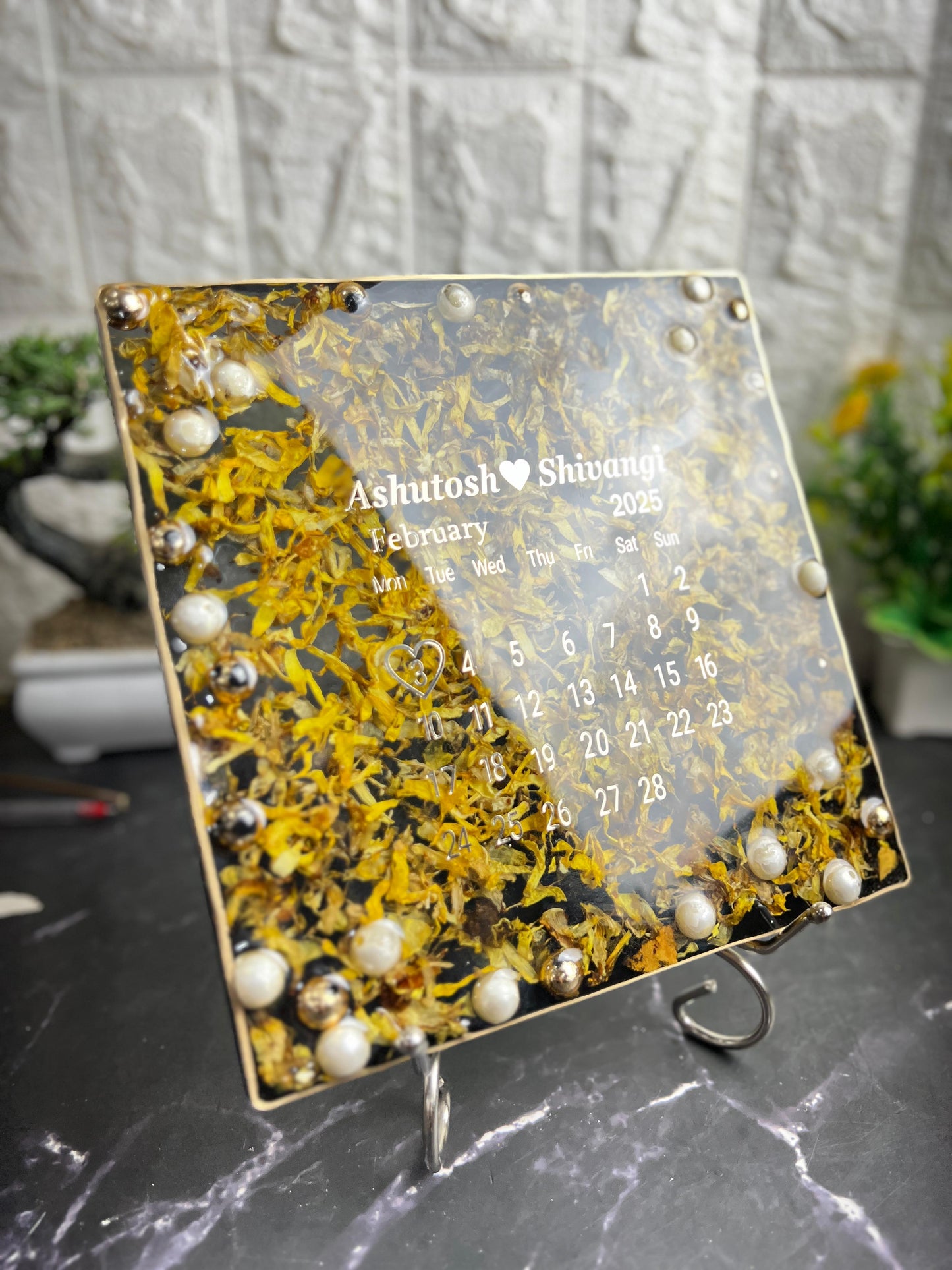 Resin 8 inch square frame with   black base petals and name date n calendar on the top with metal stand  Varmala Preservation