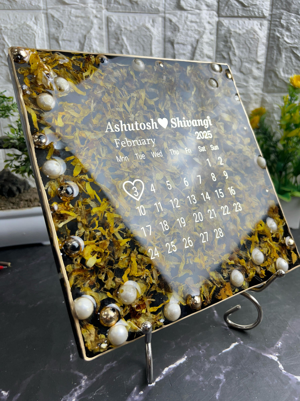 Resin 8 inch square frame with   black base petals and name date n calendar on the top with metal stand  Varmala Preservation