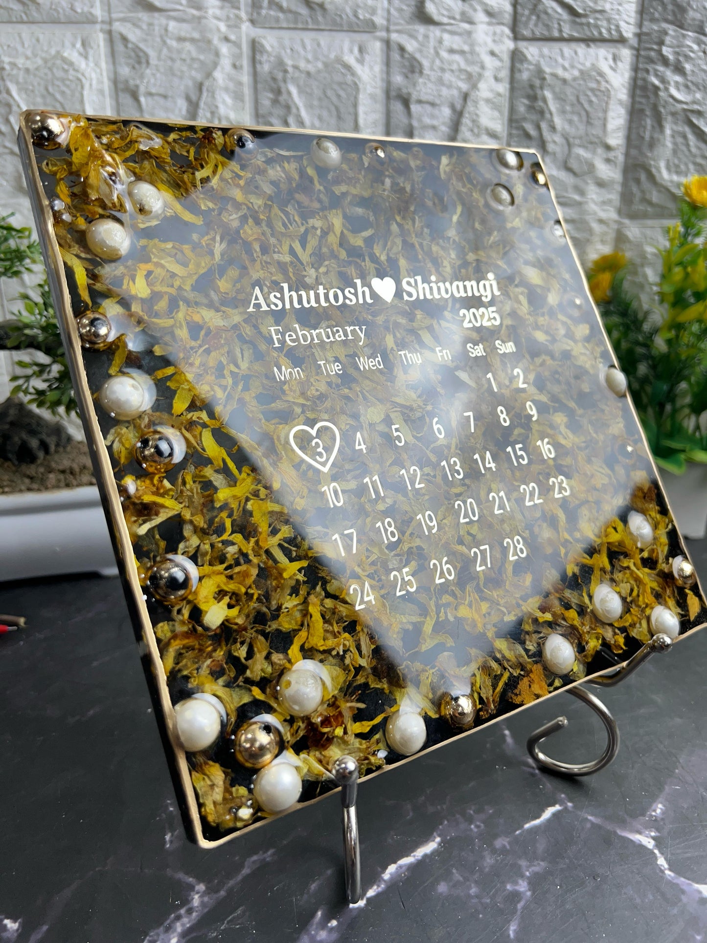 Resin 8 inch square frame with   black base petals and name date n calendar on the top with metal stand  Varmala Preservation