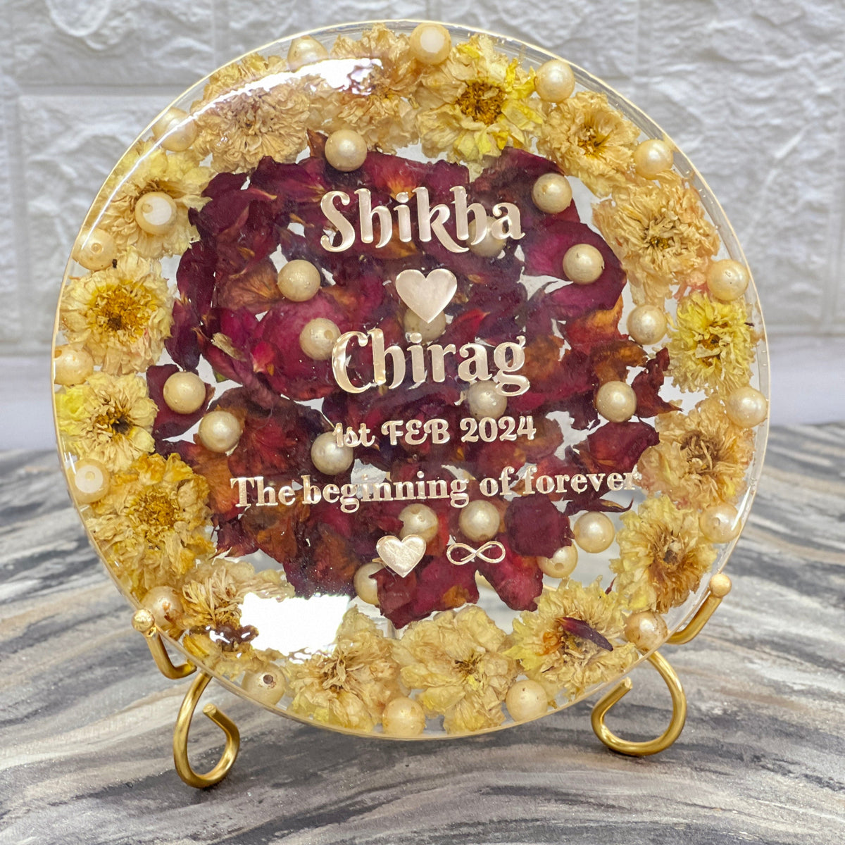 Deep cast round varmala frame with yellow flowers and red centre