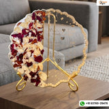 Transparent scalloped varmala frame with red and cream petals and names on a gold stand