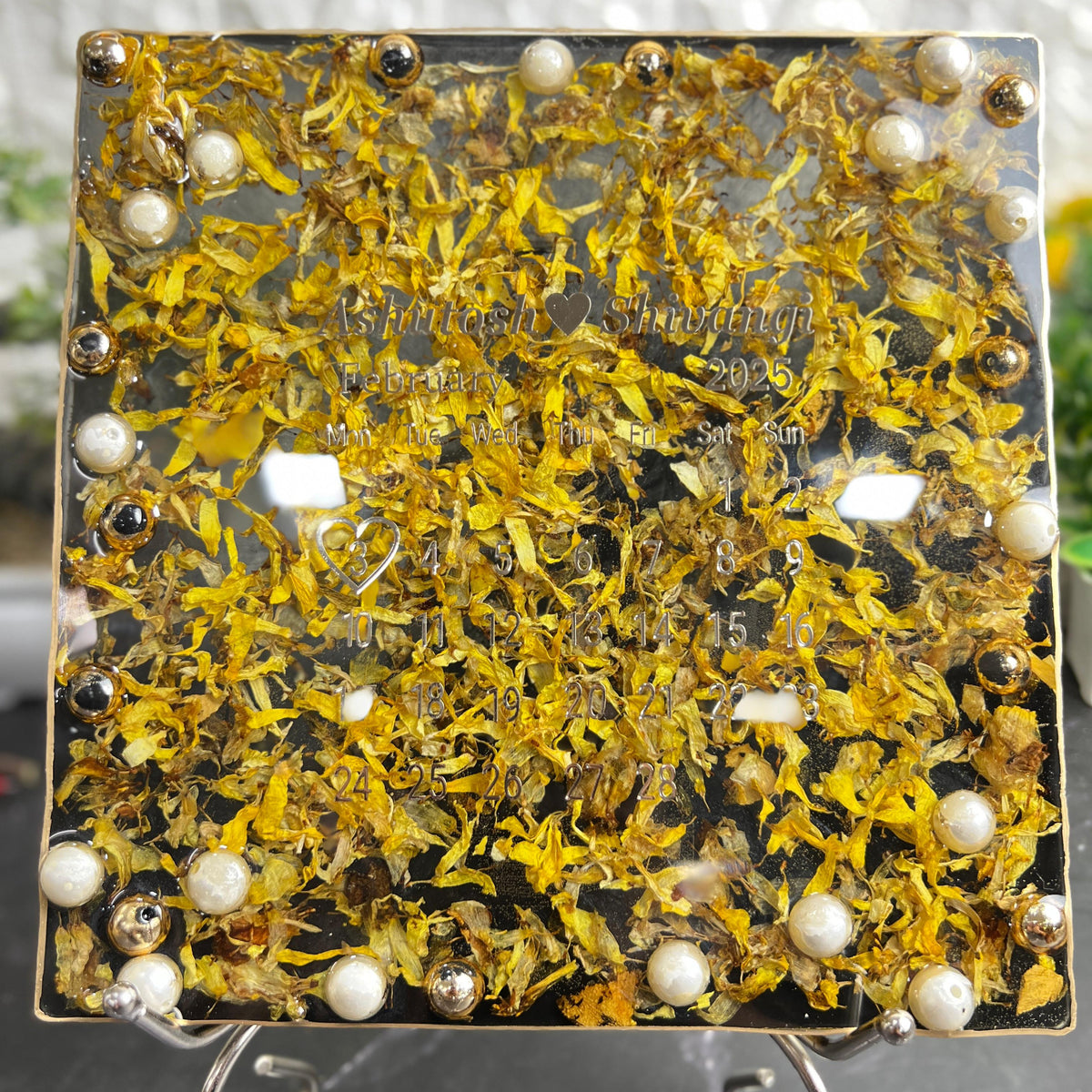 Resin 8 inch square frame with   black base petals and name date n calendar on the top with metal stand  Varmala Preservation