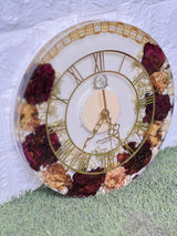 Resin 12 inch clock with In 3/4 part covered with flowers , upr part with pearl 2 lines white base in middle pink colour with logo in center Varmala Preservation