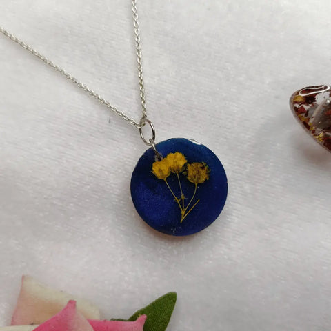blue resin pendant with preserved baby breath flower