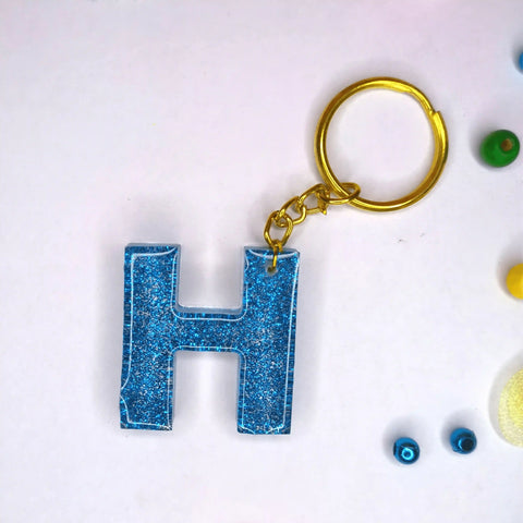 Buy Customized blue Glitter Resin keychains with H initials For Friendship day