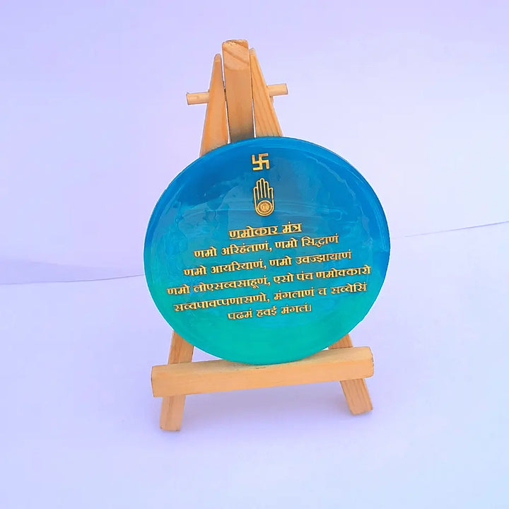 Round mini Namokar Mantra frame in ocean blue to green on a wooden easel