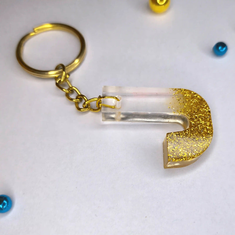 Get Trendy Golden sparkle Resin keychains with multi Alphabet Perfect Gift for Women and Girls