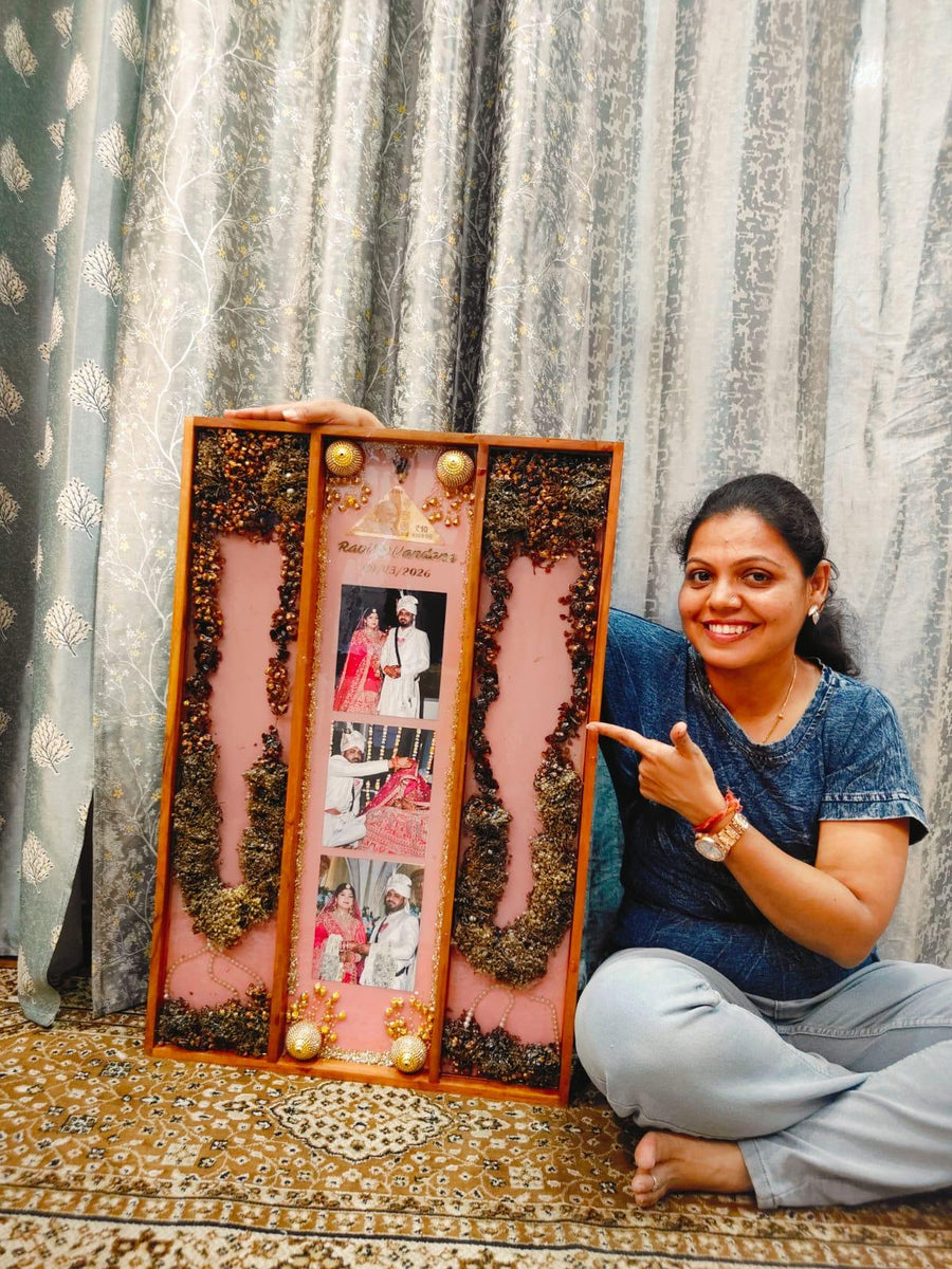 Tall pink varmala frame with couple photos, made in our Jaipur studio