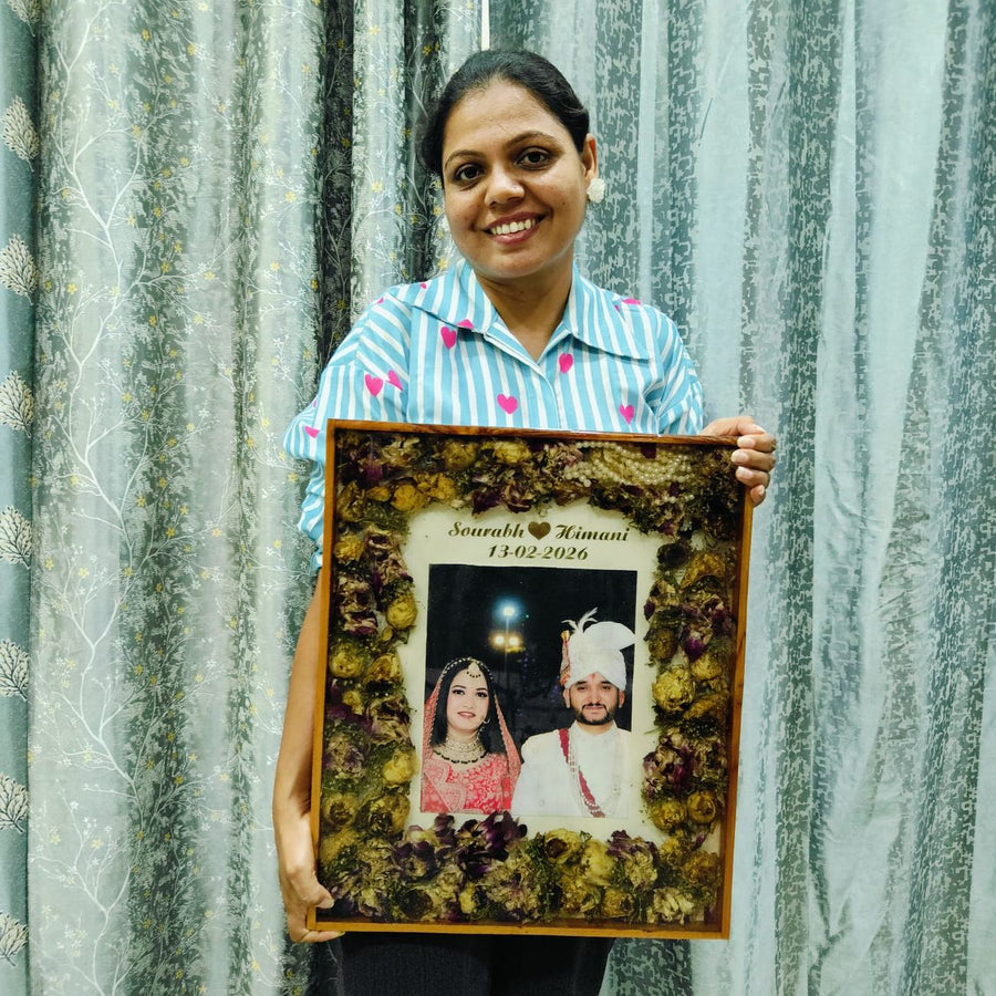 Dark varmala frame with the couple photo, names and date, made in our Jaipur studio