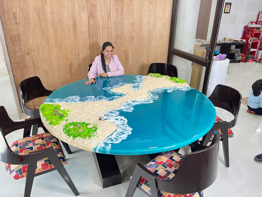 Round ocean resin dining table with a white beach edge, made in our Jaipur studio