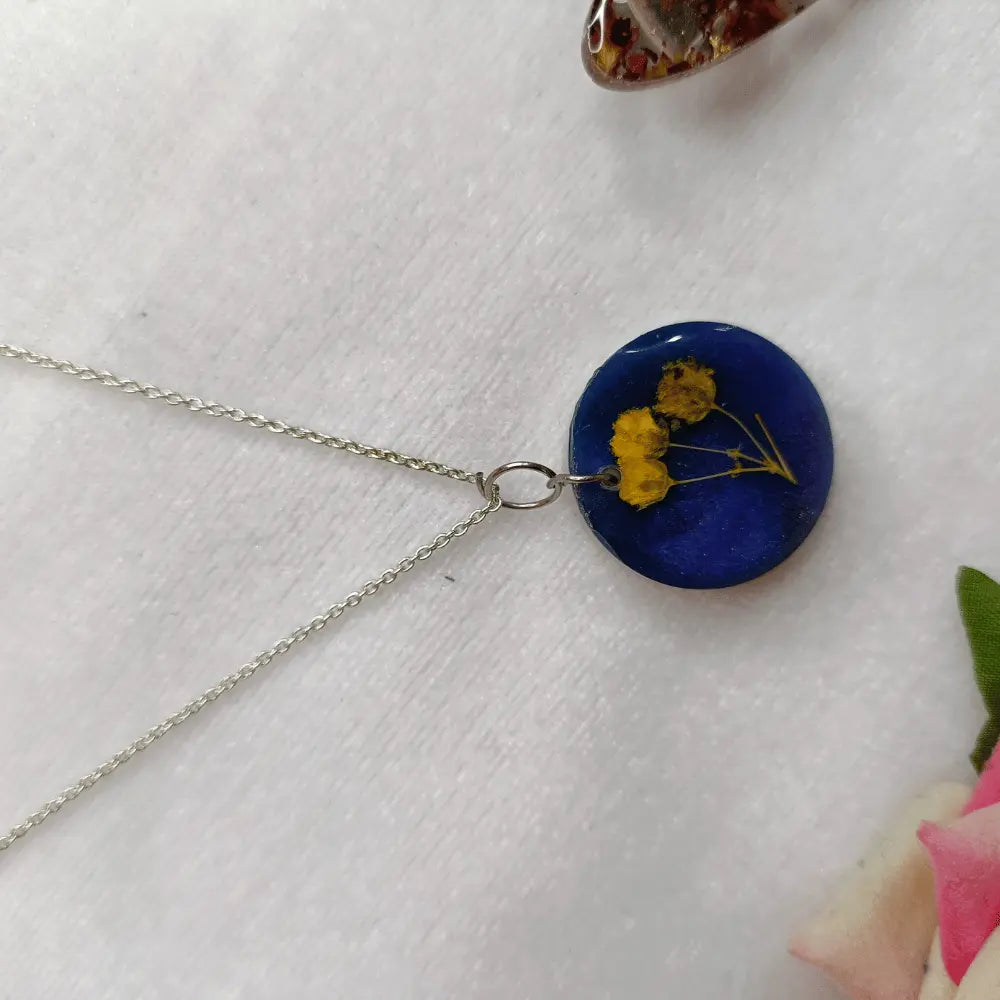 blue resin pendant with preserved baby breath flower