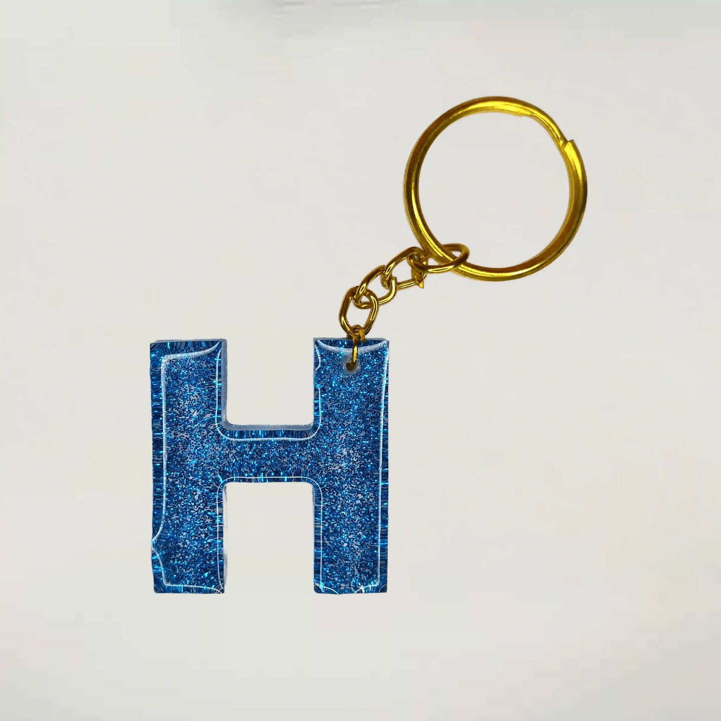 Shop Customized blue Glitter Resin keychains with H initials For Friendship day