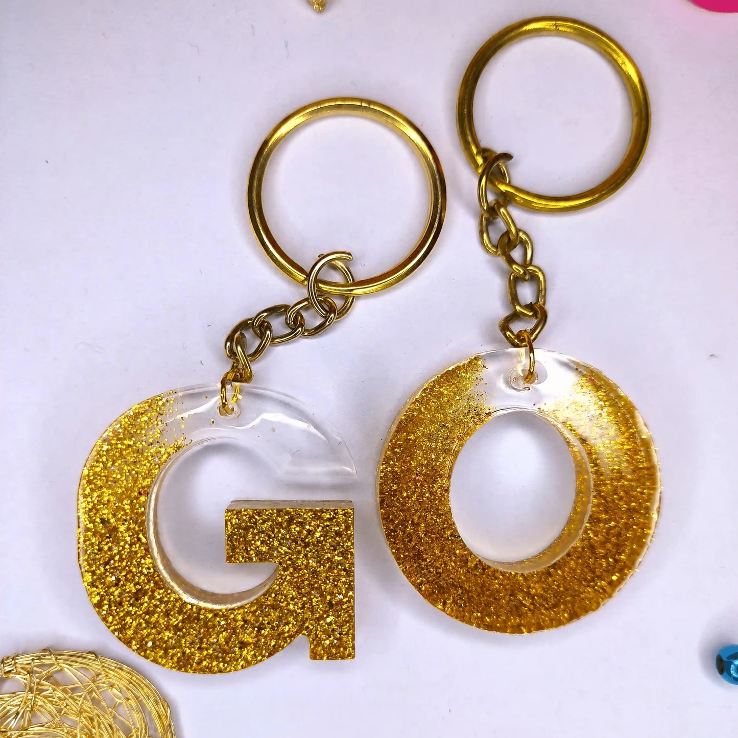 Trendy Golden sparkle Resin keychains with multi Alphabet Perfect Gift for Women and Girls For Sale