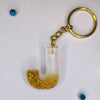 Trendy Golden sparkle Resin keychains with multi Alphabet Perfect Gift for Women and Girls Online