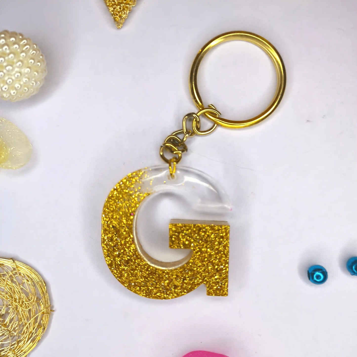 Trendy Golden sparkle Resin keychains with multi Alphabet Perfect Gift for Women and Girls